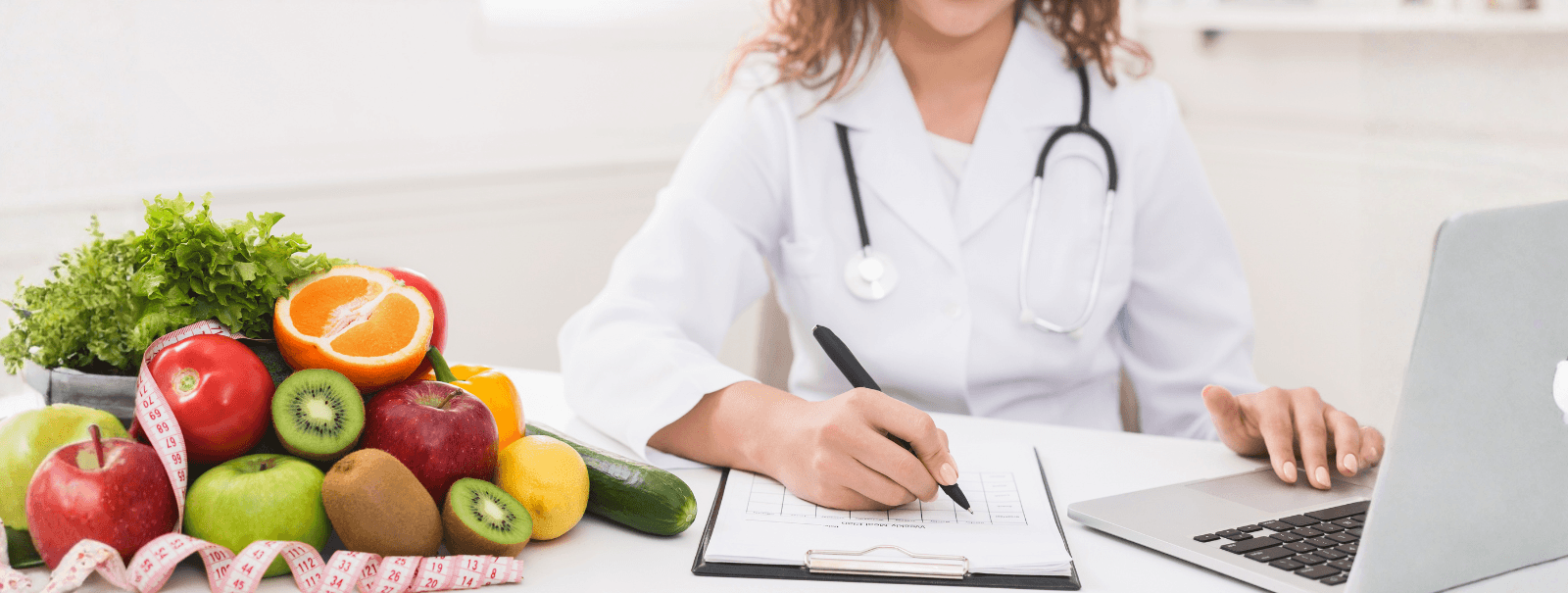 Healthcare professional creating a nutrition plan with fresh fruits and vegetables representing healthy foods for weight loss.